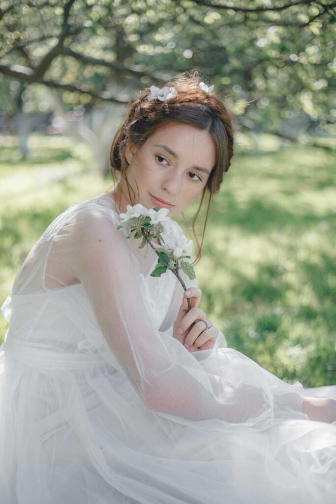 Photo Bride in Fantasia dress in a spring garden