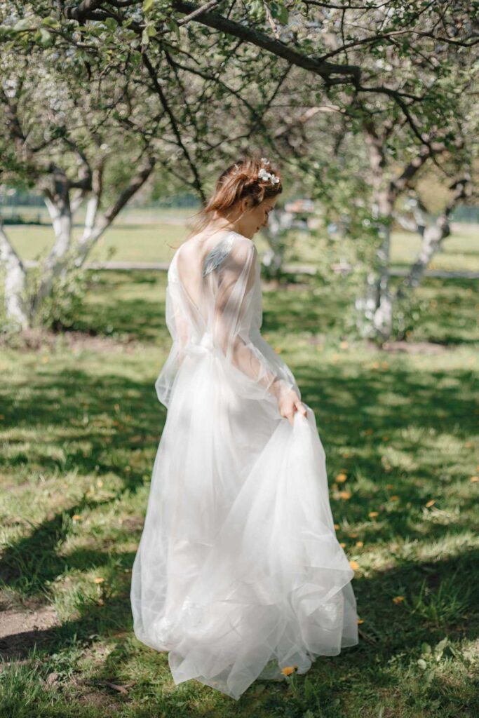 Photo Bride in Fantasia dress in a spring garden