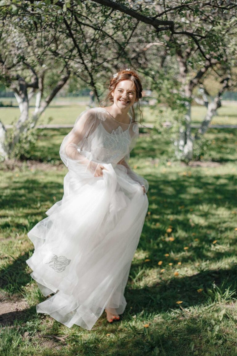 Bride in Fantasia dress in a spring garden